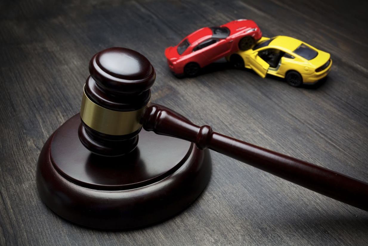 Gavel and cars depicting an accident